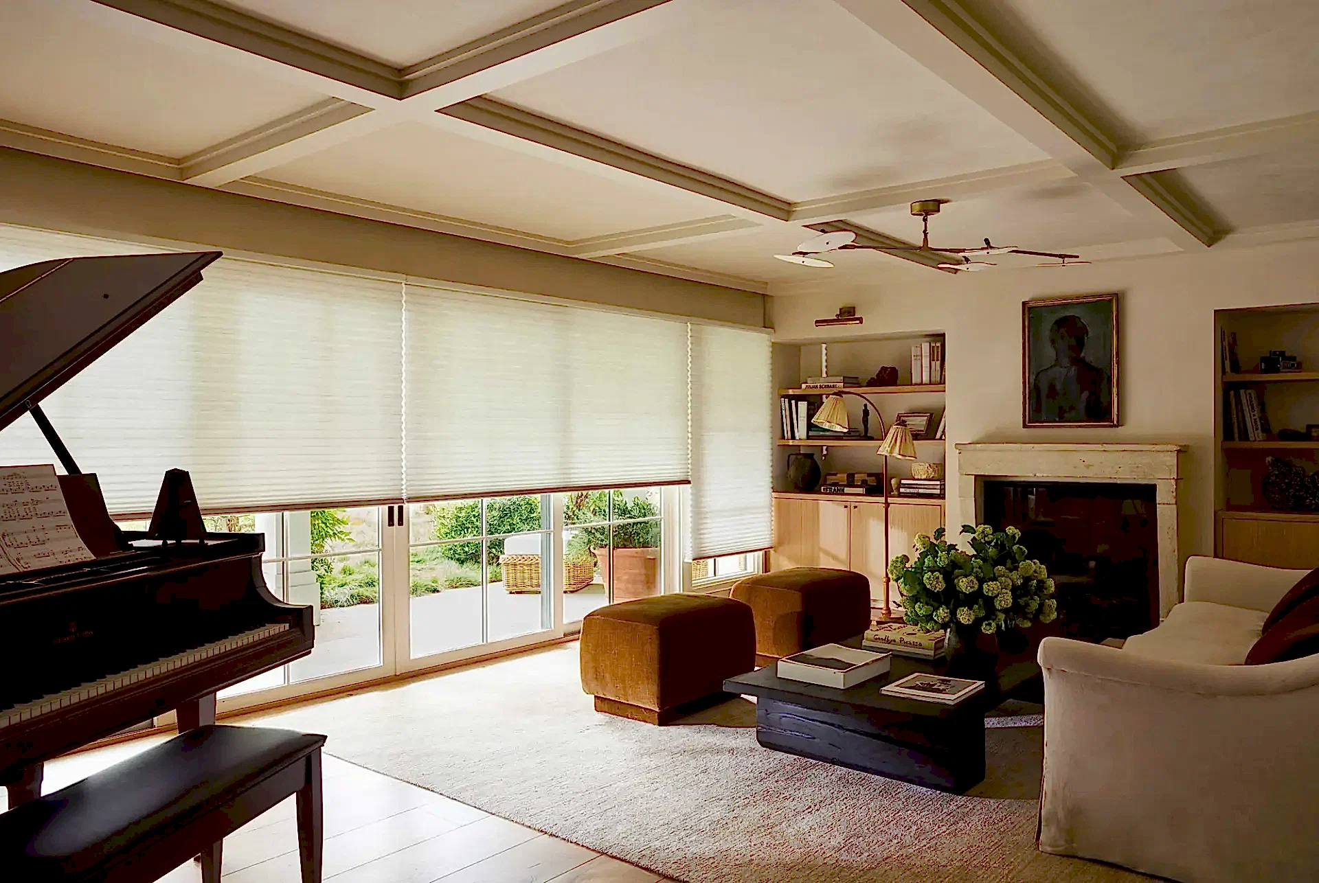 A living room with large windows featuring Hunter Douglas shades.